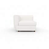 A white Rituals sofa corner unit with a cushioned backrest and seat, set against a plain background.